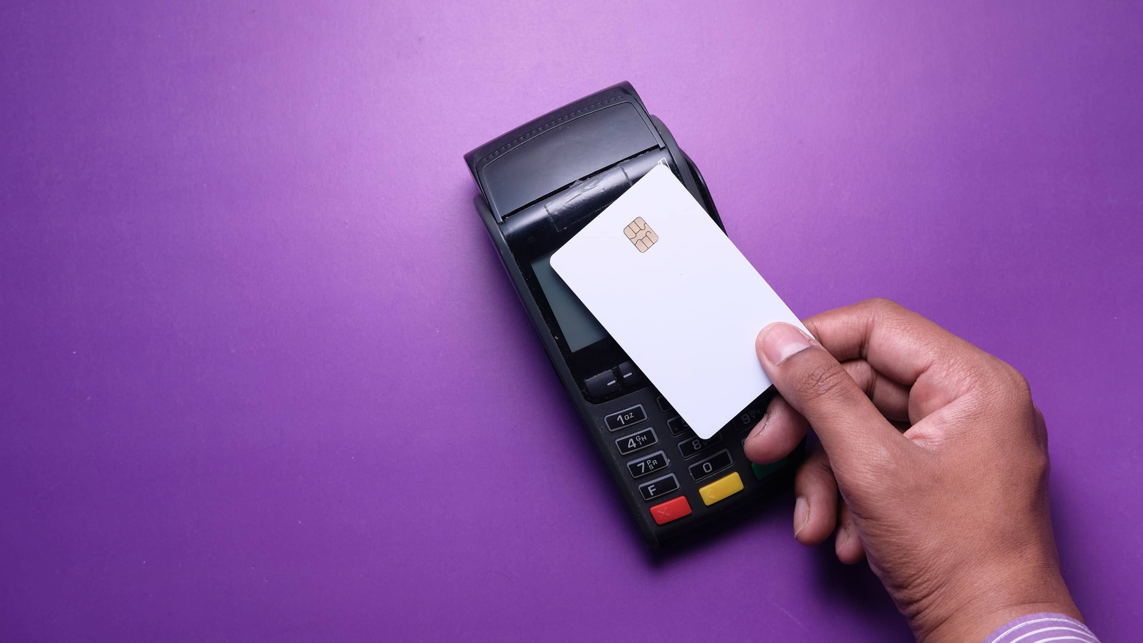 Card payment terminal on a purple counter