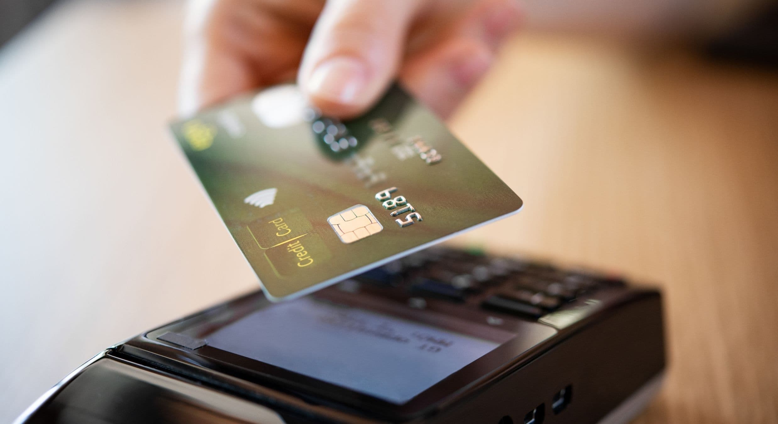 Customer tapping a card on a payment terminal